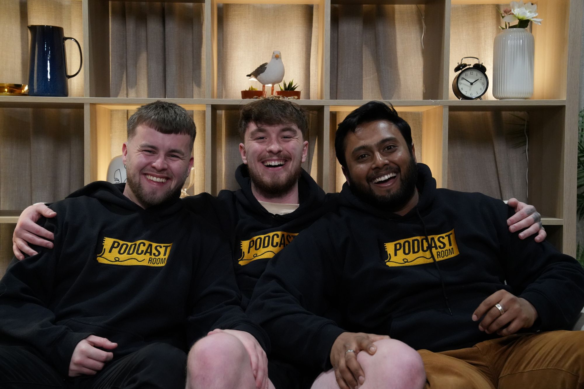 Three young men smile for the camera