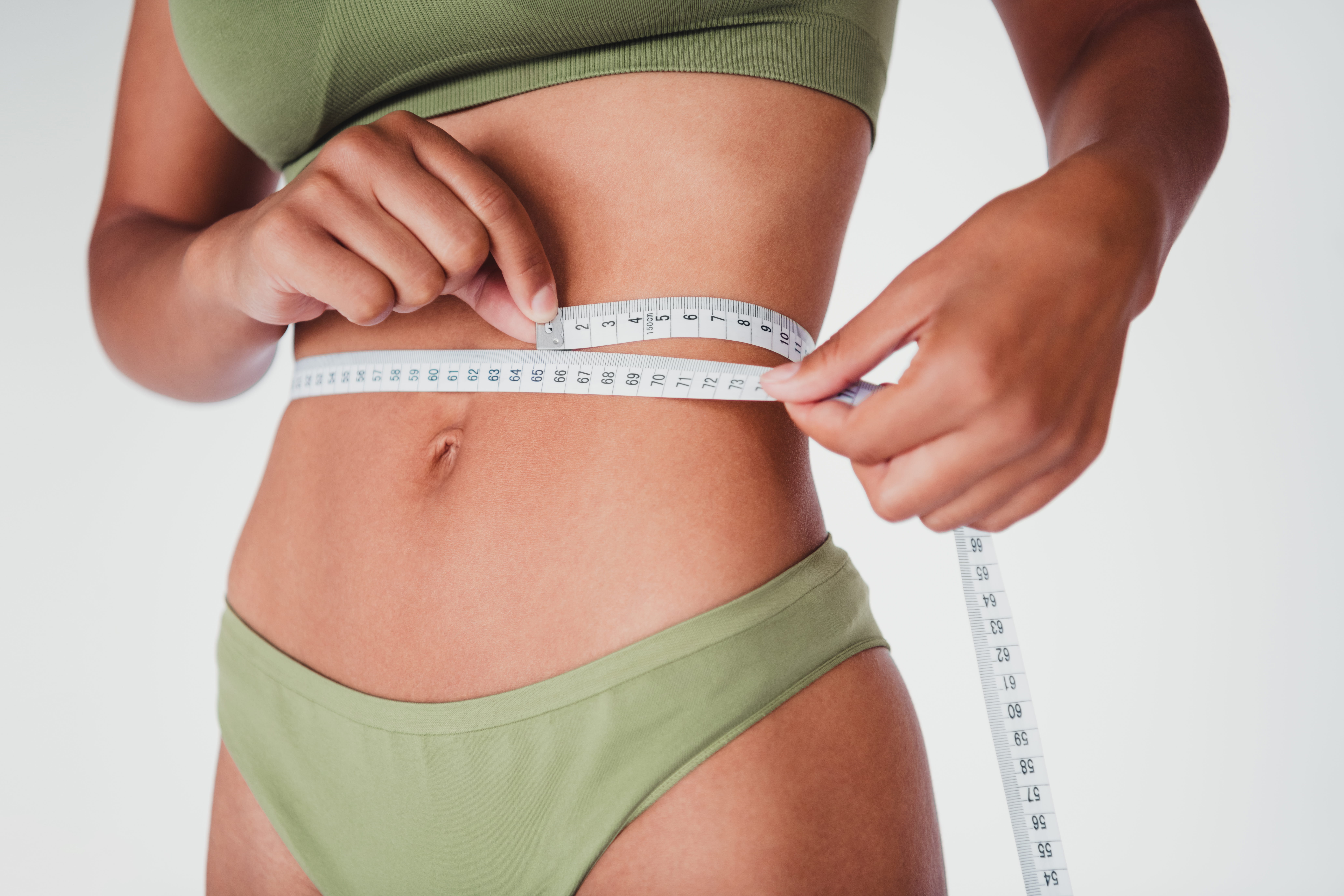 Woman measures waist