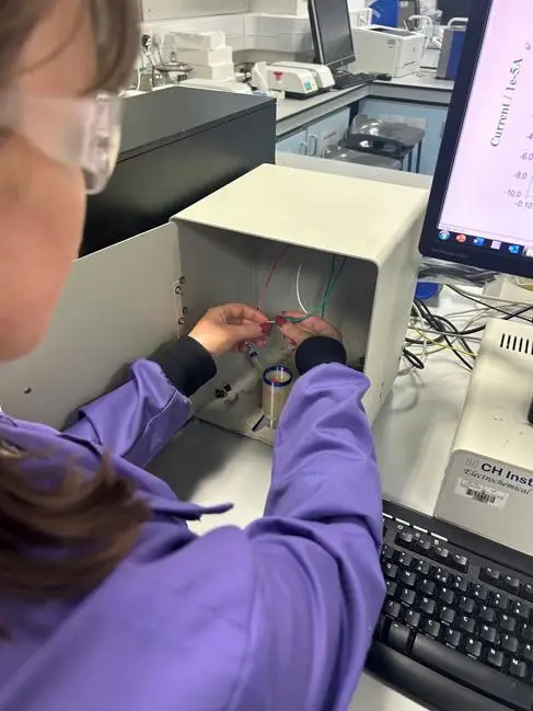 A female scientist plays with a 3D printing electronic sensor in a lab