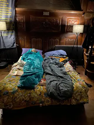 Two people in sleeping bags in Thomas Pain Chapel