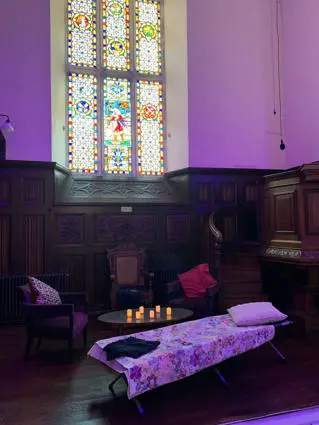 A single bed in Tom Paine's Chapel, Lewes