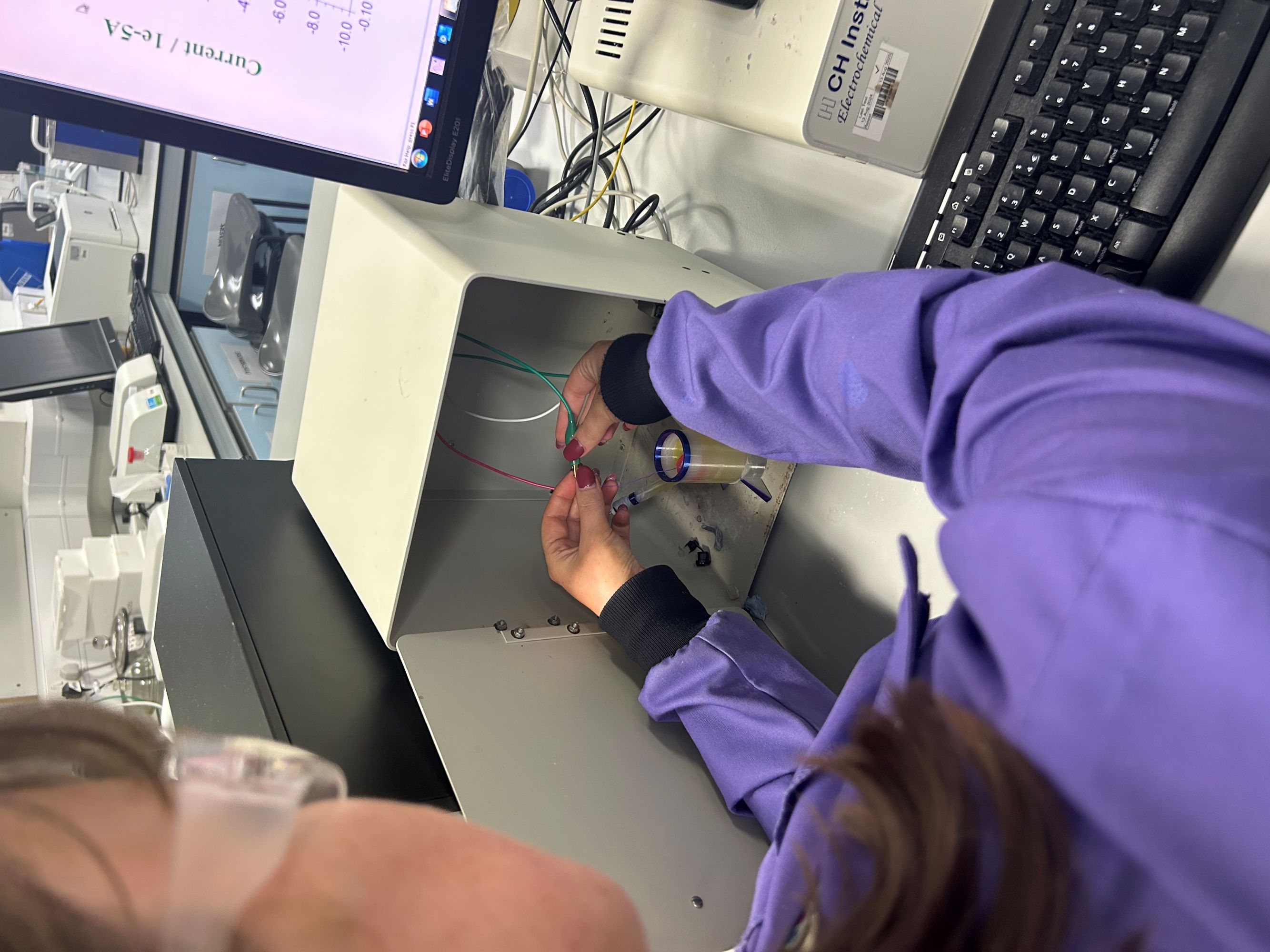 A female scientist plays with a 3D printing electronic sensor in a lab