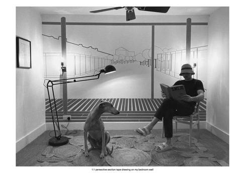A room with an architectural drawing on one wall