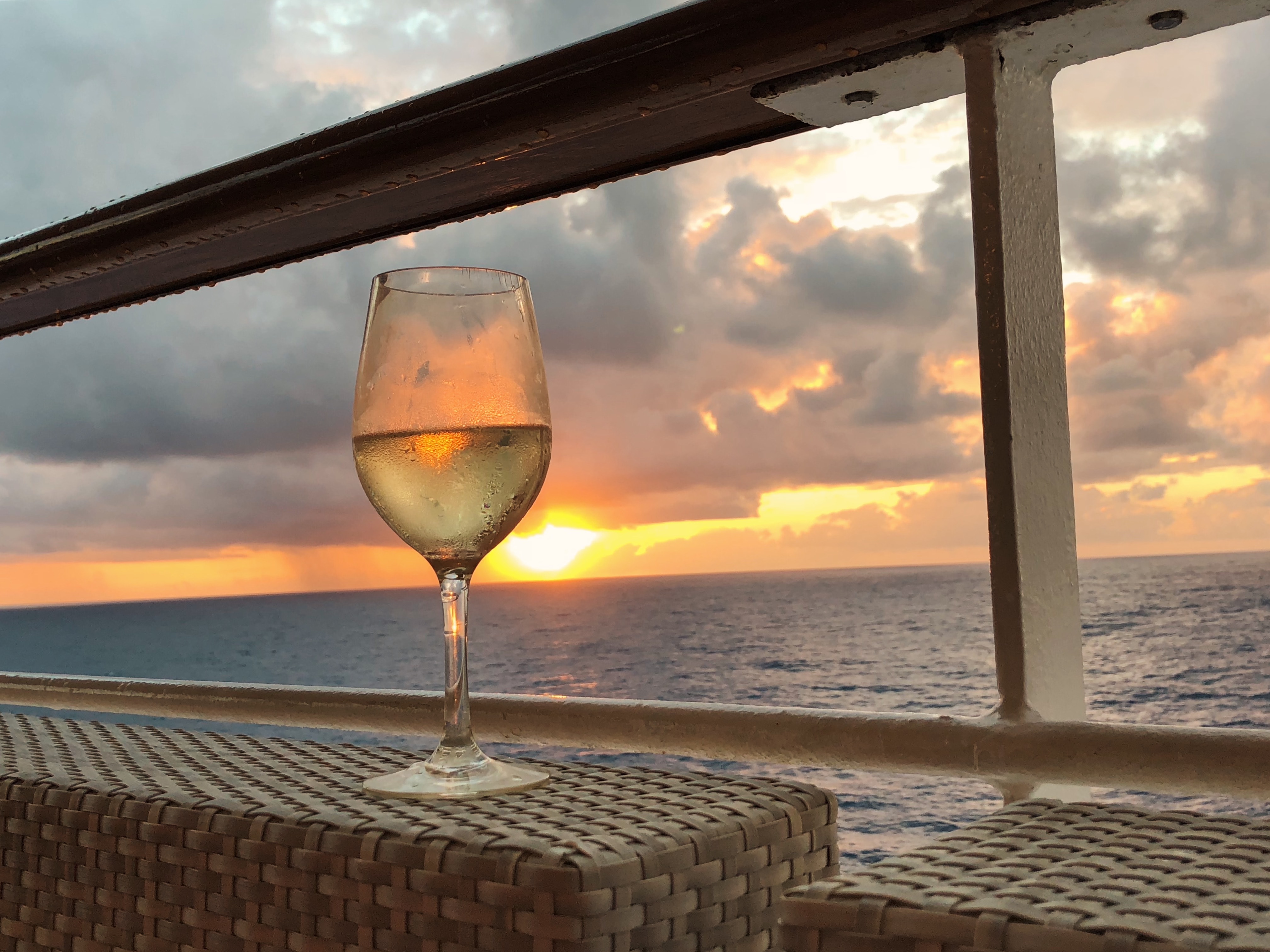Glass of wine in the sunset on a cruise ship Photo by Reiseuhu on Unsplash