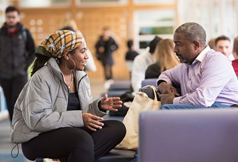 A student having a discussion with an older person