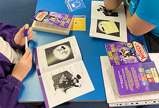 A student ambassador reading with a secondary school child