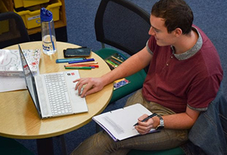 A student working on a laptop in a library