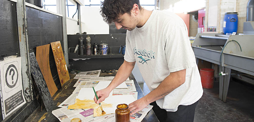 Printmaking student using facilities