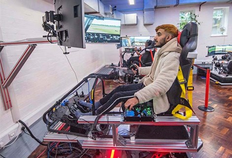 Male student using the flight simulator cropped