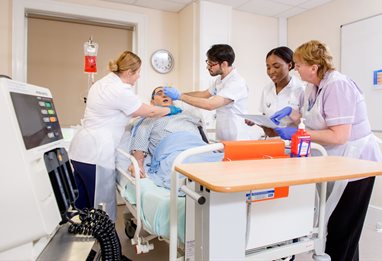 Medical students practising on a dummy