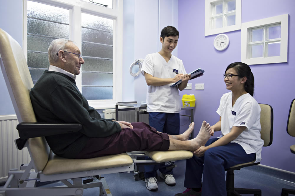 Podiatry students and elderly patient