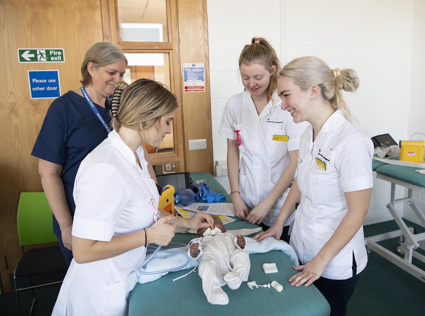 nursing students with a child mannequin