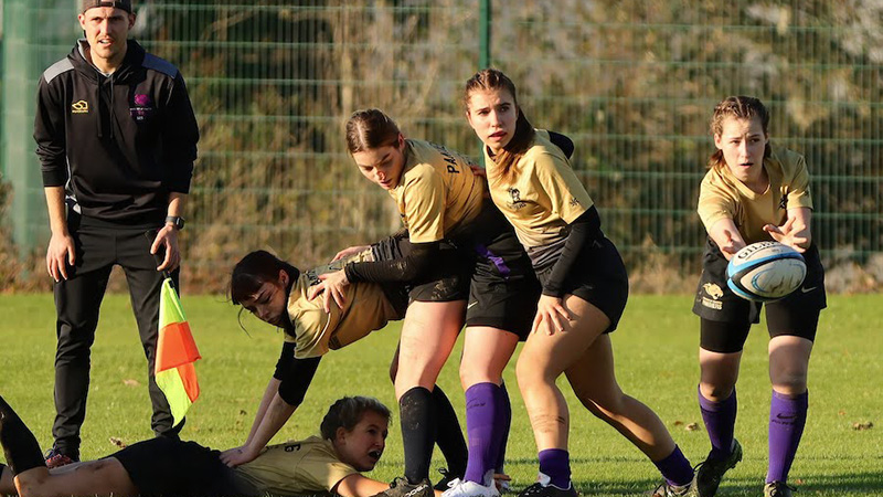 female students playing rugby