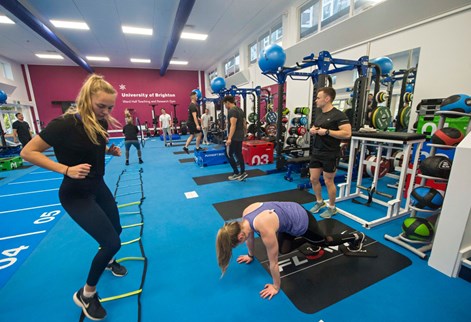 Female sports student side stepping in gym class