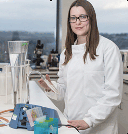 Dr Sarah Purnell standing in a lab
