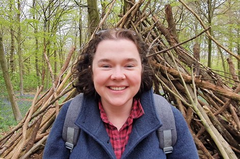 Emma Johnston with sticks and forest in background