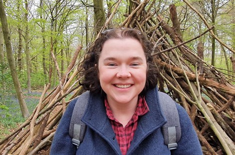 Emma Johnston with sticks and forest in background