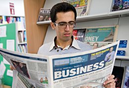 Student reading newspaper