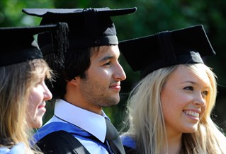 Three students in gowns and mortar boards