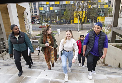 A group of students climbing steps