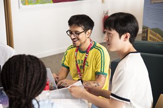 Students sitting around a table, talking