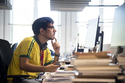 A student using a computer in a university library