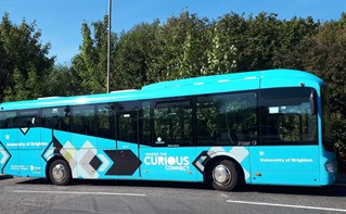 Blue bus with University of Brighton branding